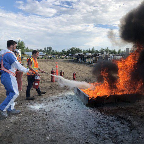 Matt and Kyle working together to put out at Fire Extinguisher Training 2020
